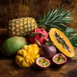 Summer Drink with Two Tropical Fruits including, pineapple, papaya, and passion fruit on a wooden table