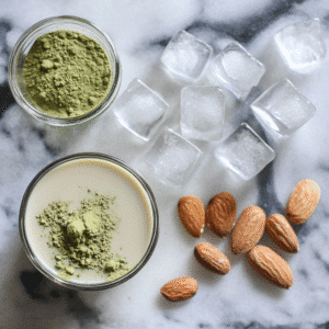 Ingredients for Low Calorie Iced Matcha Latte: matcha powder, almond milk, stevia, and ice cubes